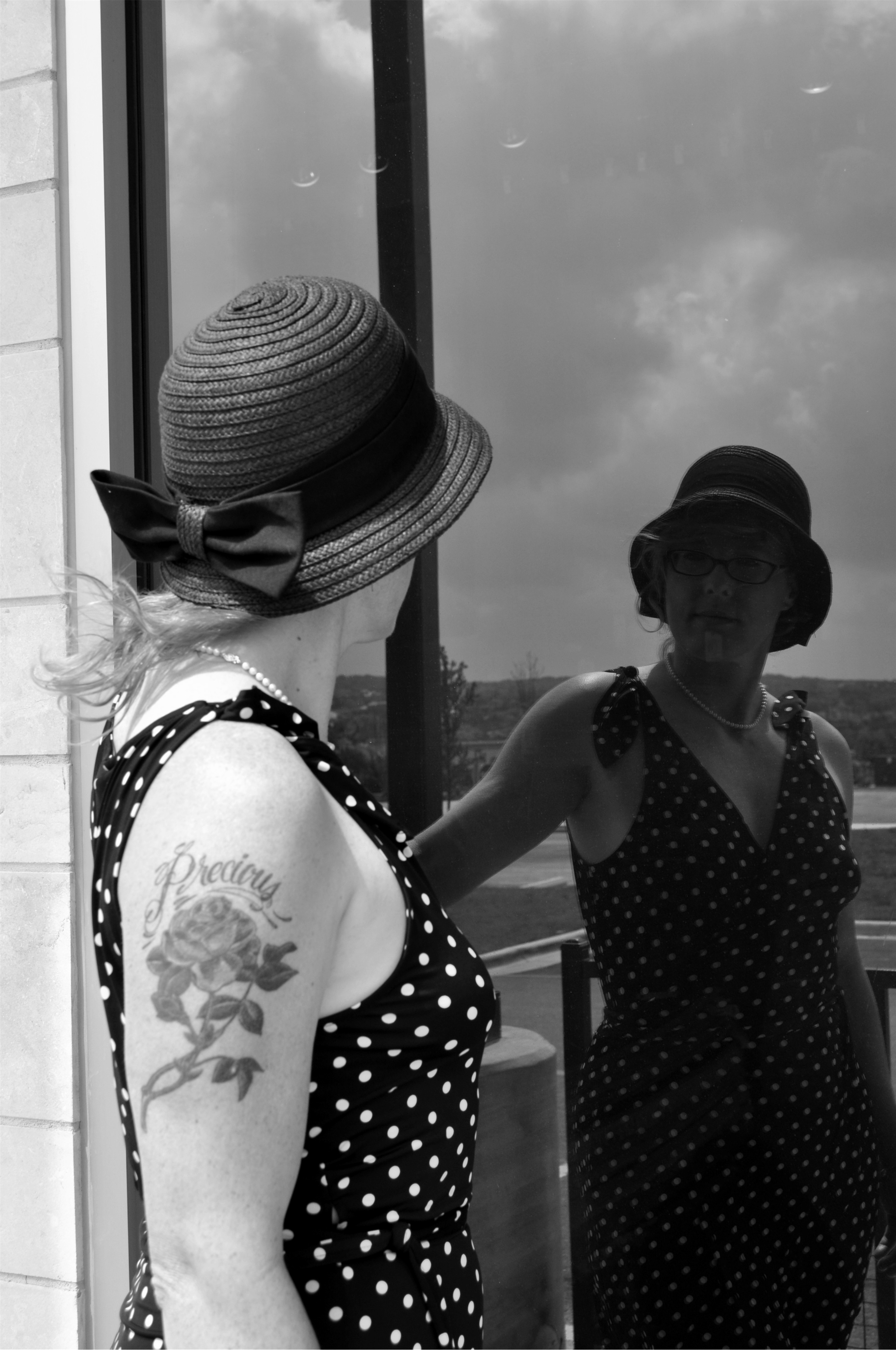Two women in matching polka-dot outfits and hats — playfulness, sisterhood, being human together