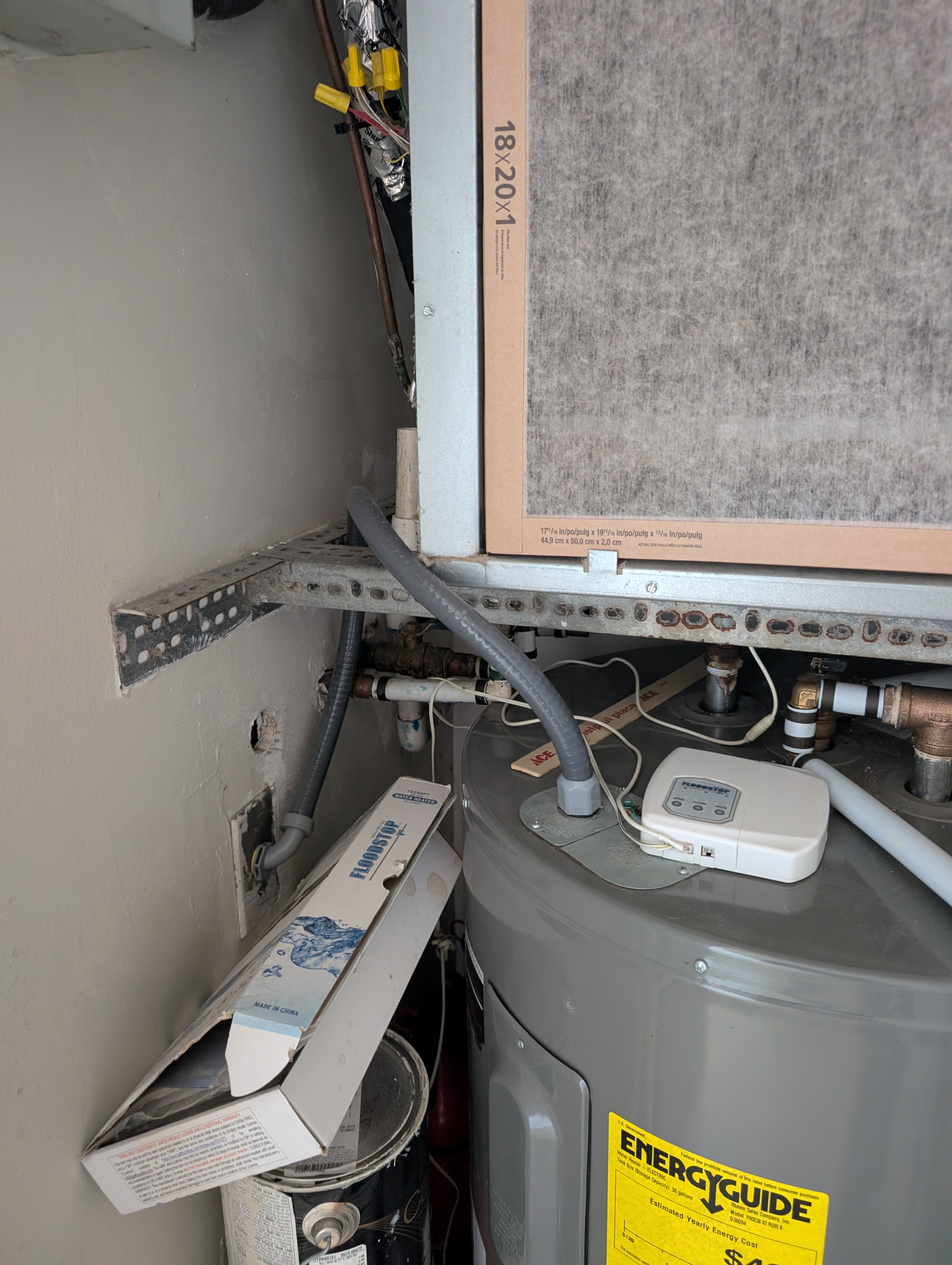 Utility closet with water heater and plumbing