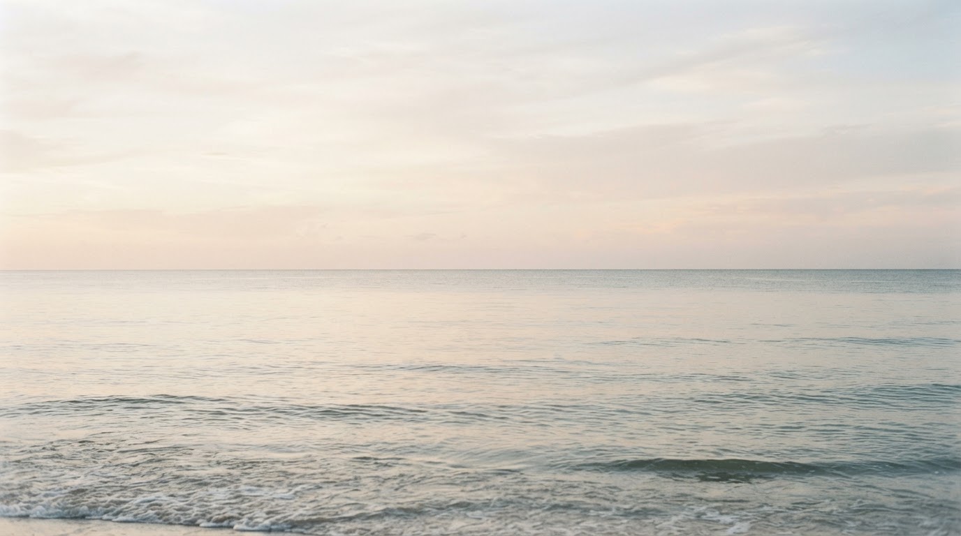 Calm ocean horizon at dawn in soft pastel tones