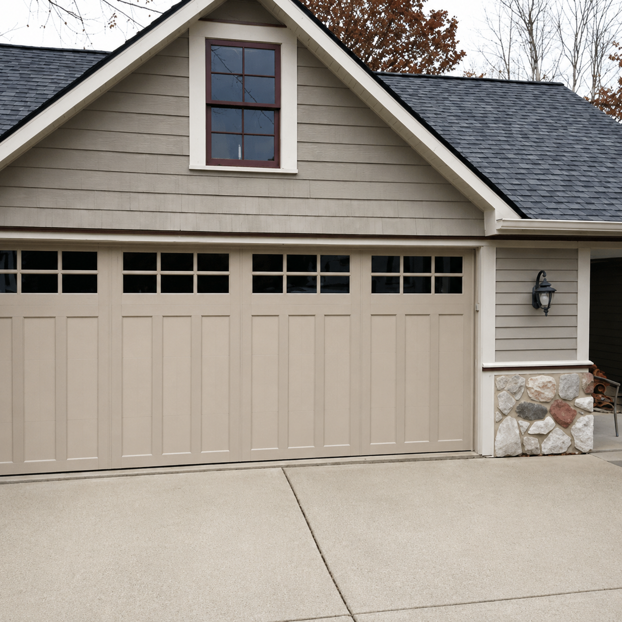 Classic carriage-style garage door with stone accents installed by JT Garage Doors in Fremont