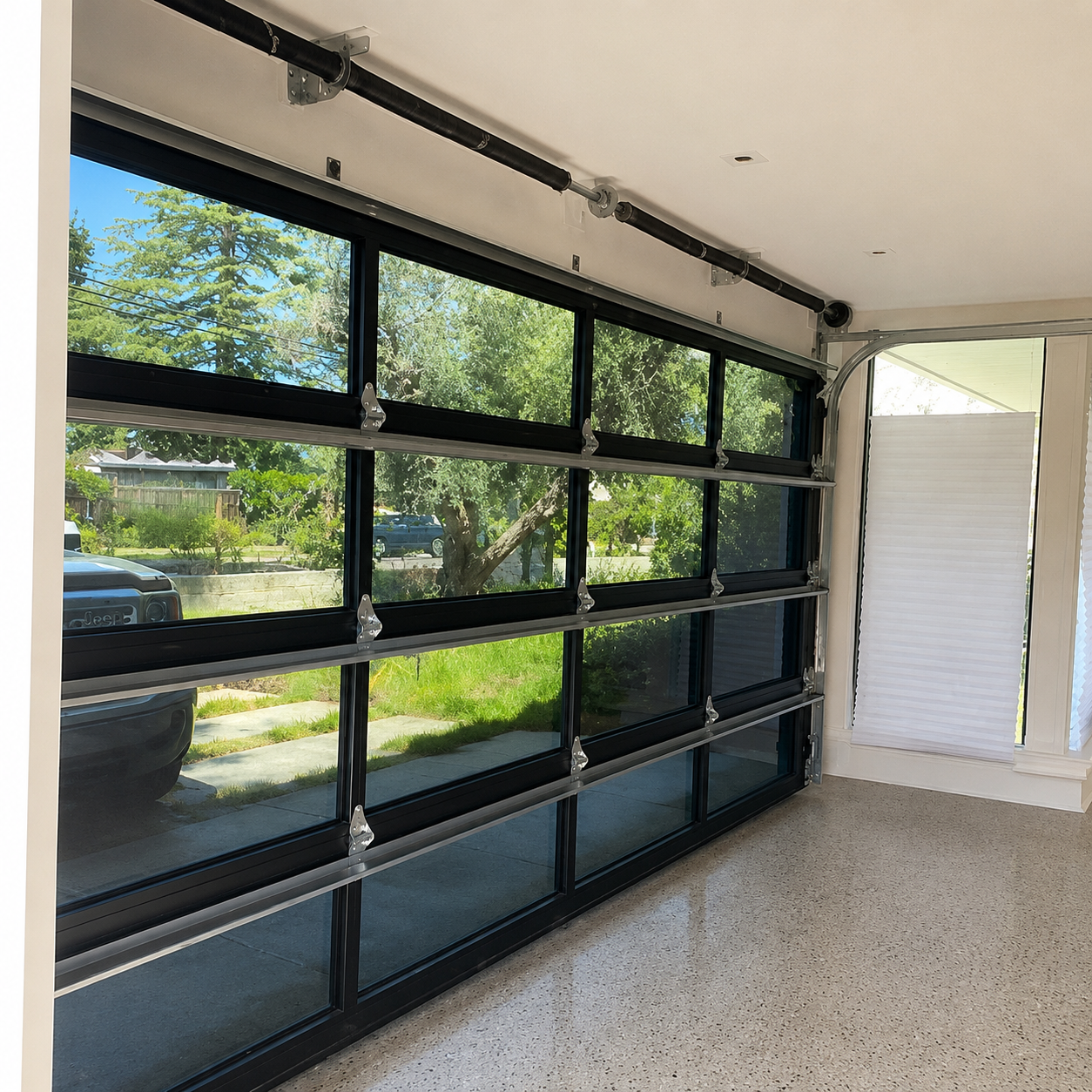 Interior view through custom aluminum-and-glass sectional garage door installed by JT Garage Doors in the Bay Area