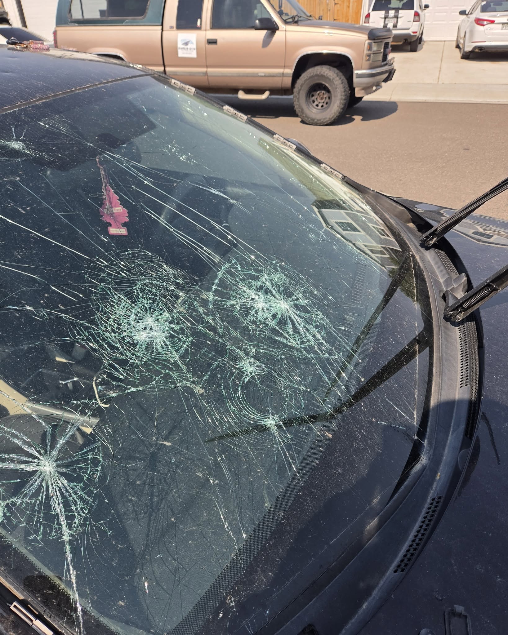 Severely cracked and damaged windshield before repair