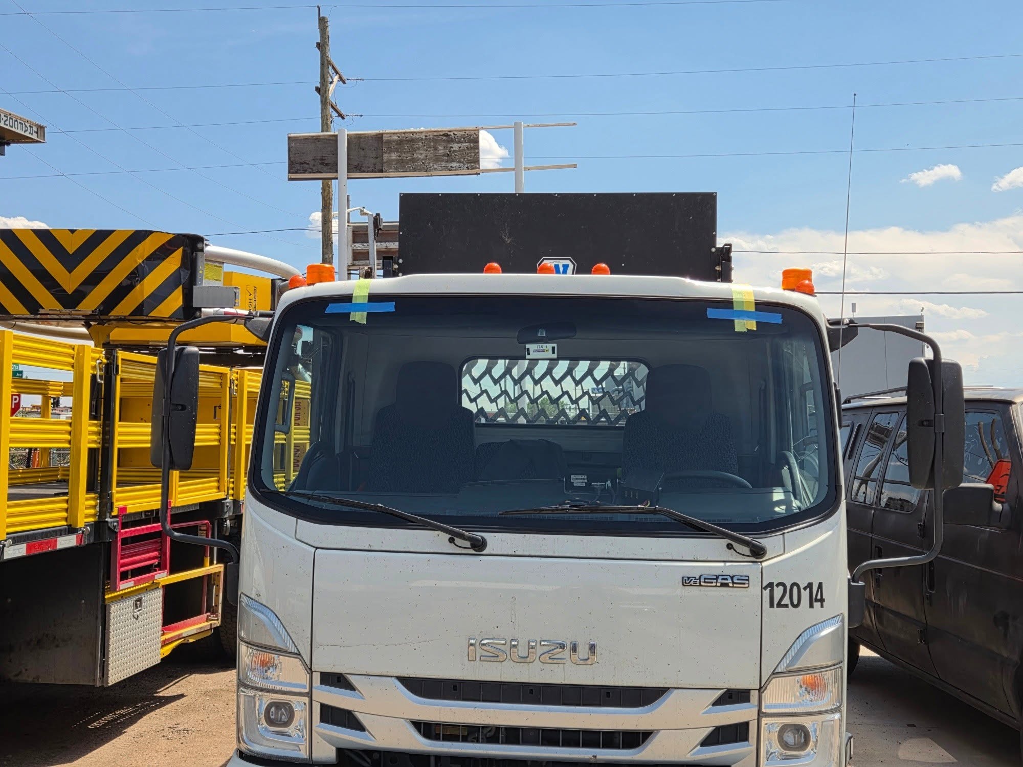 Isuzu commercial truck with newly installed pristine windshield ready for service