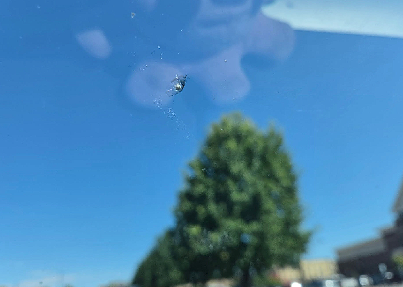 Rock chip bullseye damage on car windshield before repair