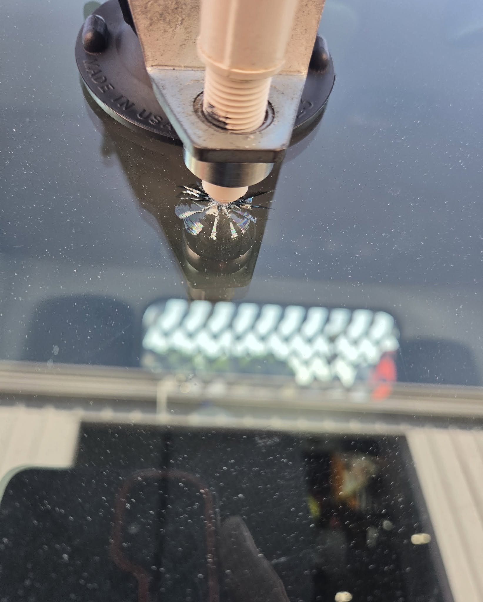 Close-up of rock chip repair process using professional resin injection tool