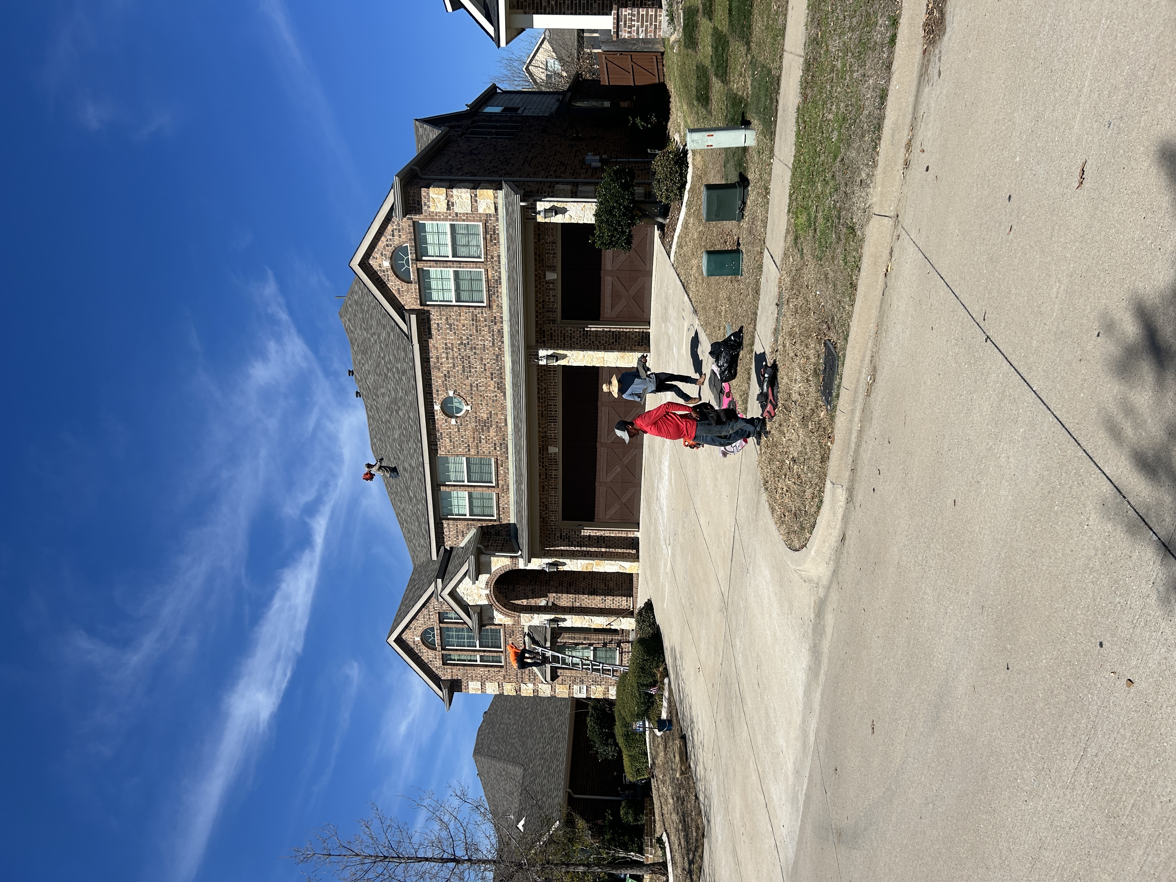Job site cleanup and debris trailer at a North Texas roof replacement project