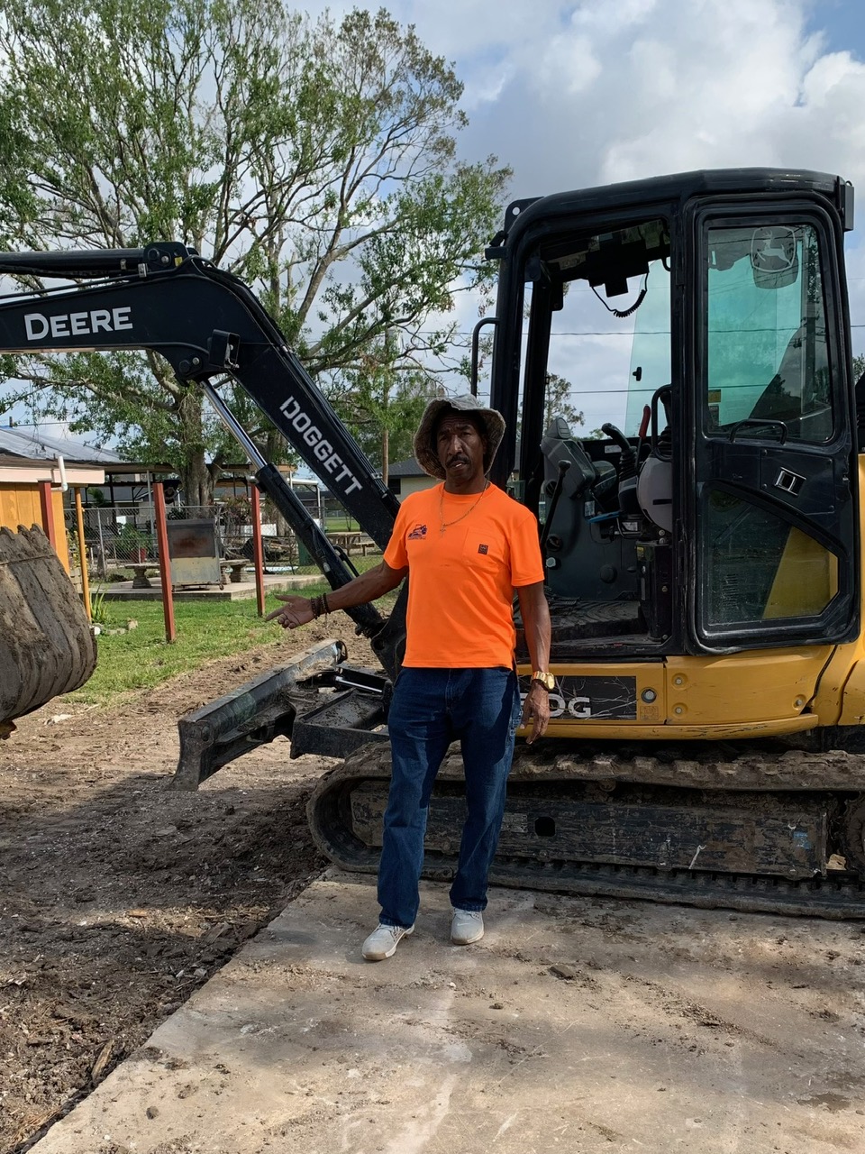 Owner Clarence Clement with John Deere excavator on a South Louisiana job site