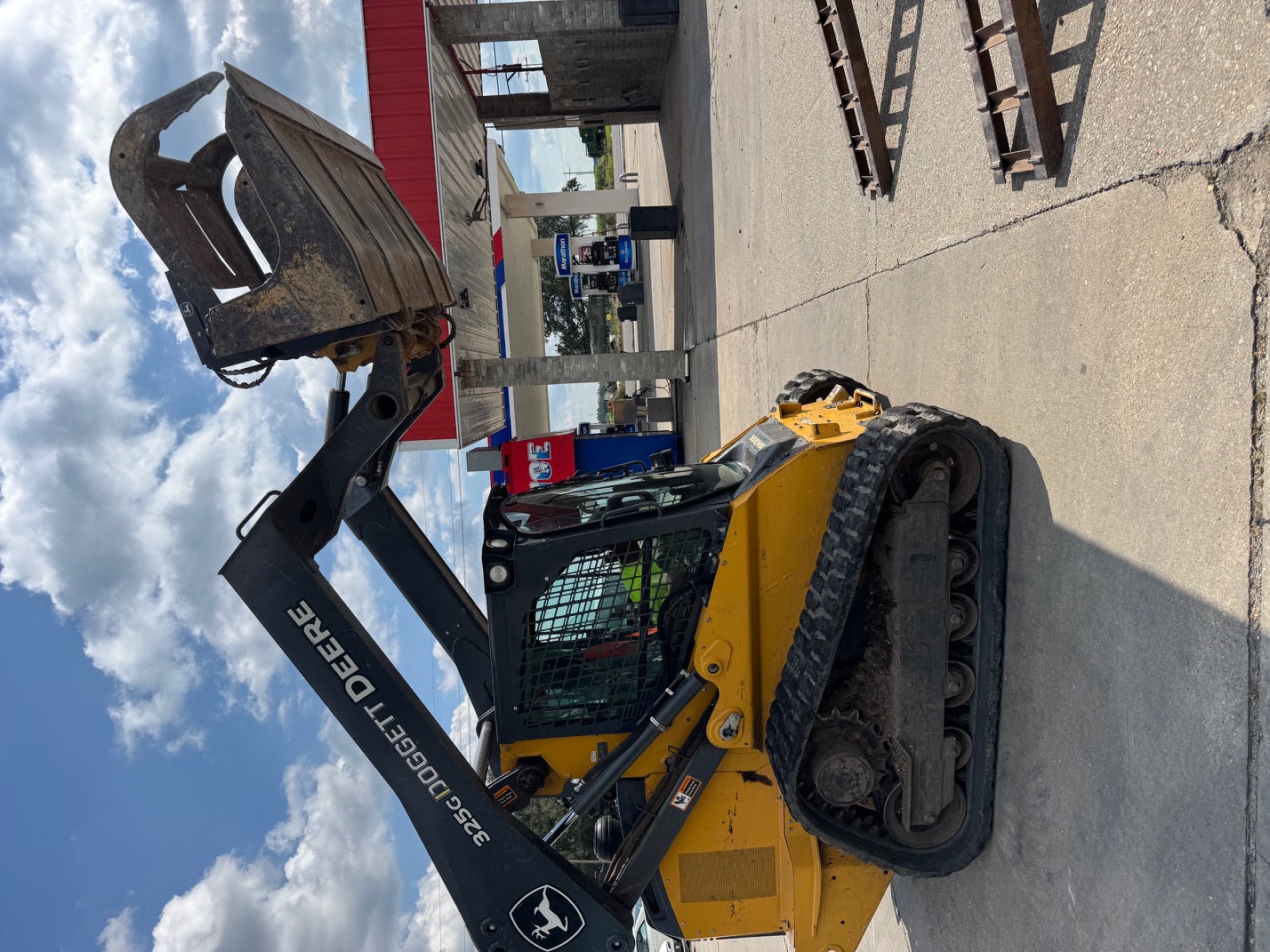 John Deere 325G compact track loader with grapple attachment ready for demolition work