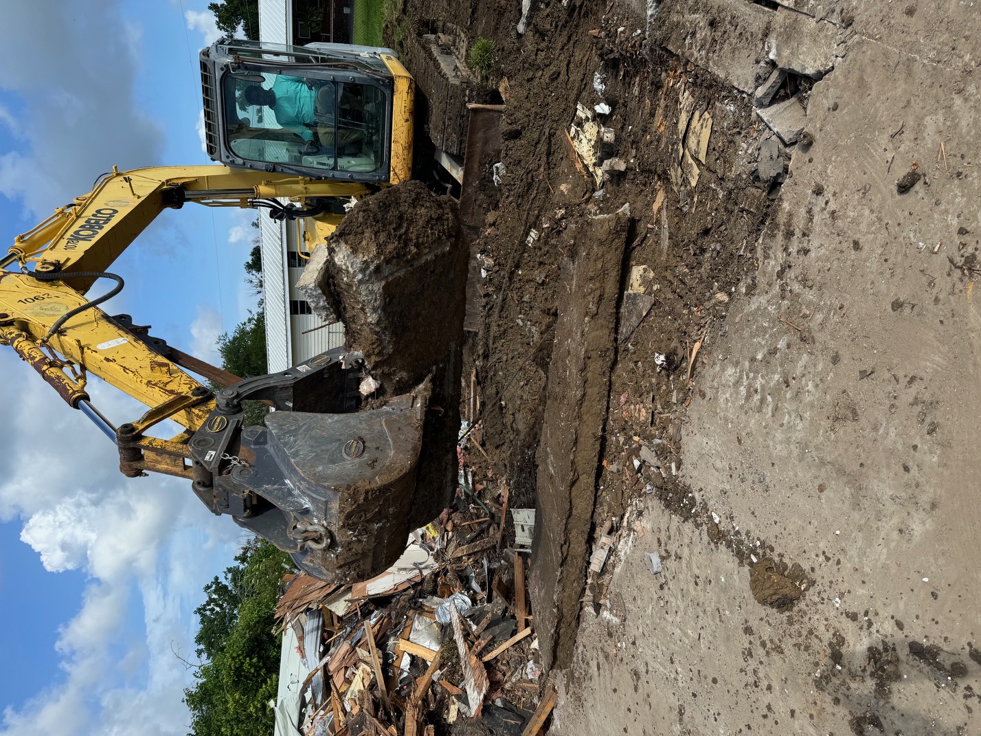 Yellow Cubox excavator at a demolition site in South Louisiana