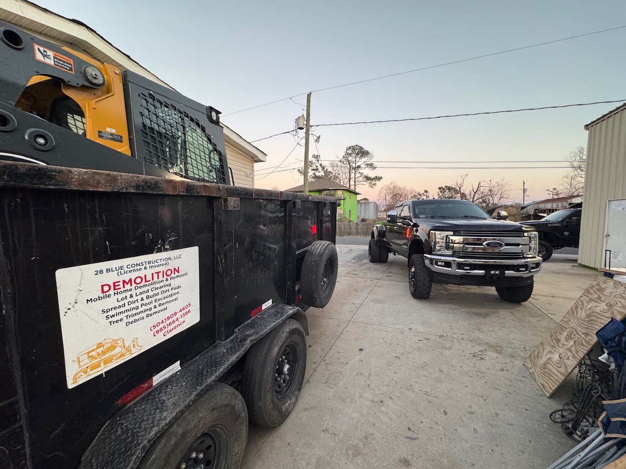 28 Blue Construction LLC branded dump trailer showing demolition and hauling services