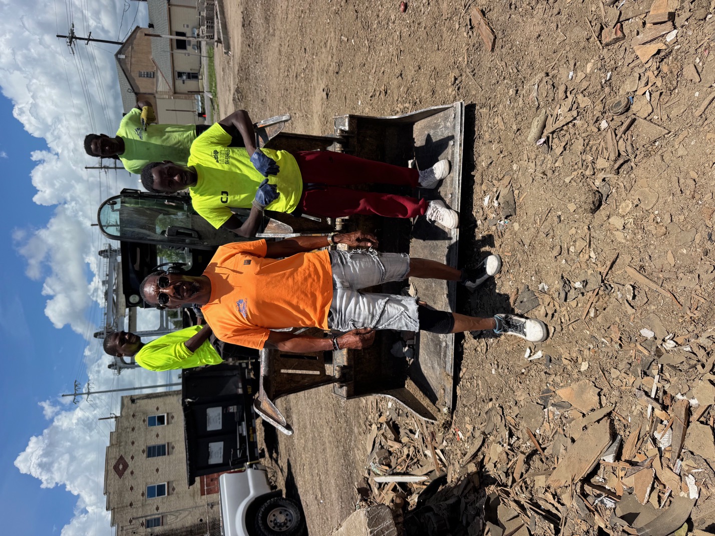 Clrence Clement and the 28 Blue Construction crew posing together on heavy equipment