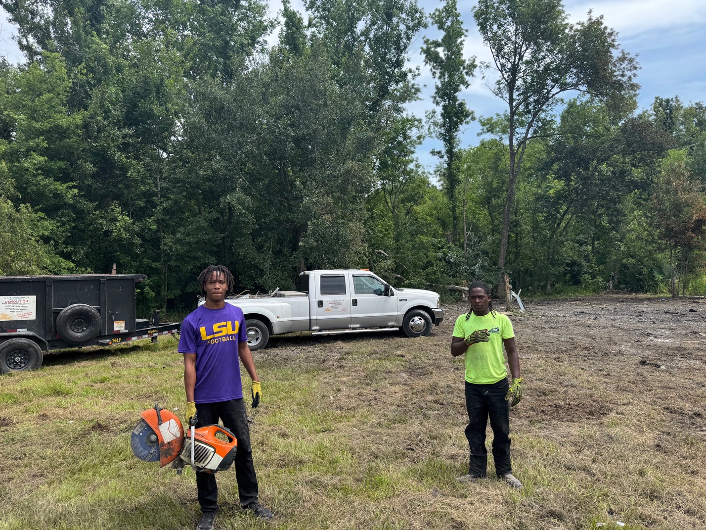 28 Blue Construction crew with chainsaw and equipment on a South Louisiana job site