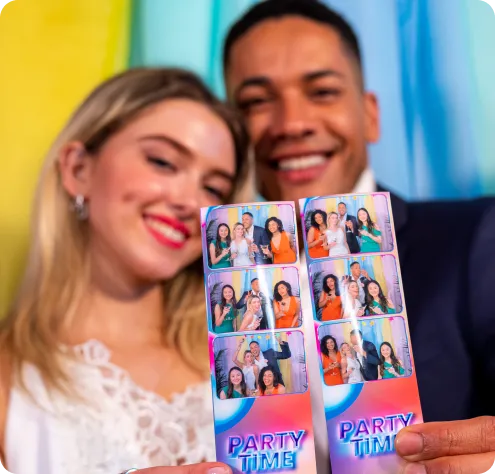 Couple showing off their photo booth strips