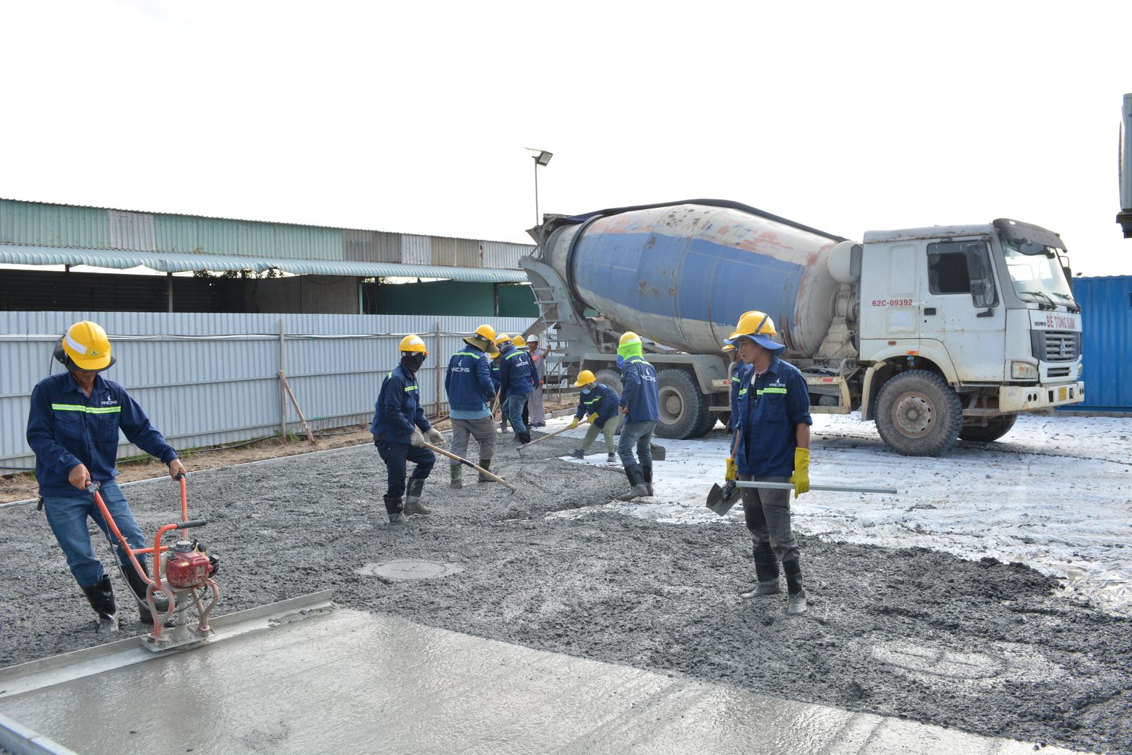 Crew pouring concrete from a mixer truck on a job site — concrete equipment financing for contractors