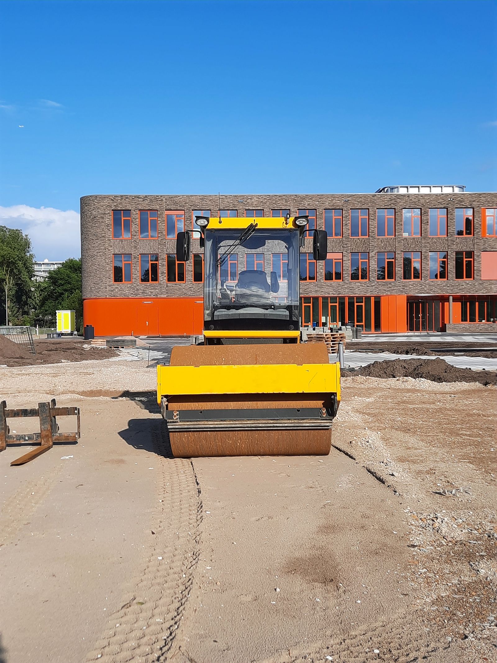 Yellow roller compactor on a construction site — roller and compaction equipment financing