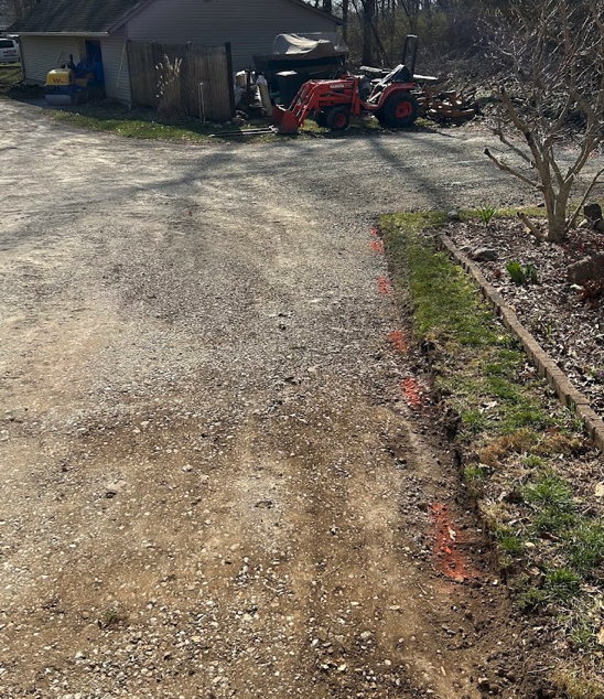 Gravel and dirt residential driveway before paving by Always Sealcoating