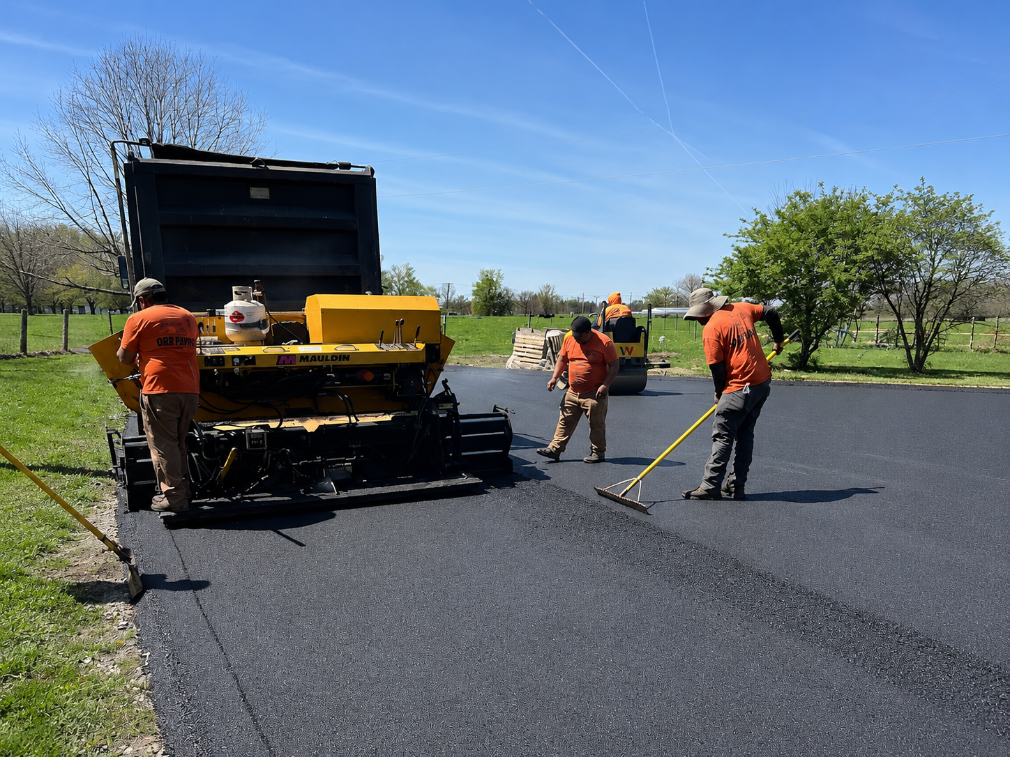 Always Sealcoating & Paving crew applying fresh asphalt
