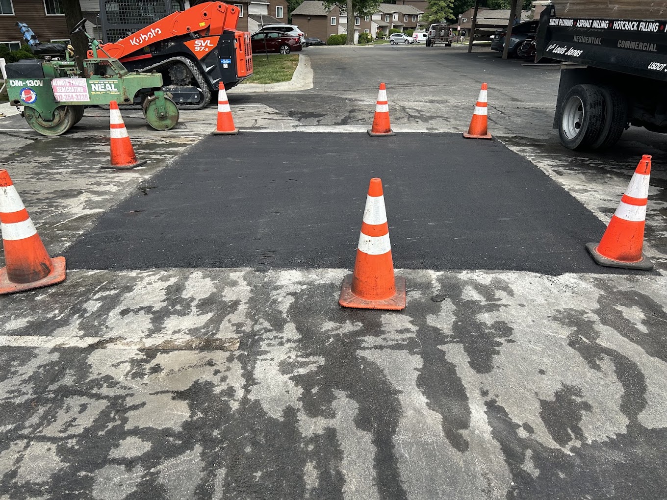 Freshly paved asphalt driveway with roller and equipment โ Danville, IN