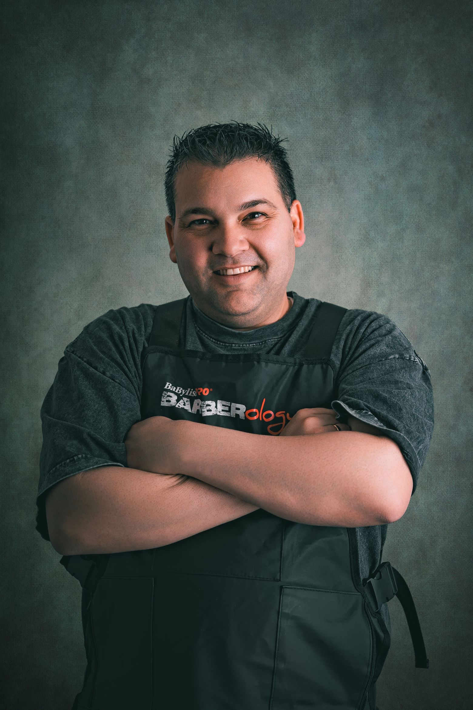 Smiling portrait of Lazaro, barber at LA Barber Downey