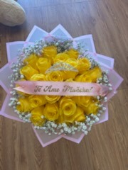 Vibrant yellow Ecuadorian rose round bouquet framed with white baby's breath, crystal crown tiara, and 'Te Amo Muñeca!' ribbon in pastel star-point wrap by FridAndre Florals