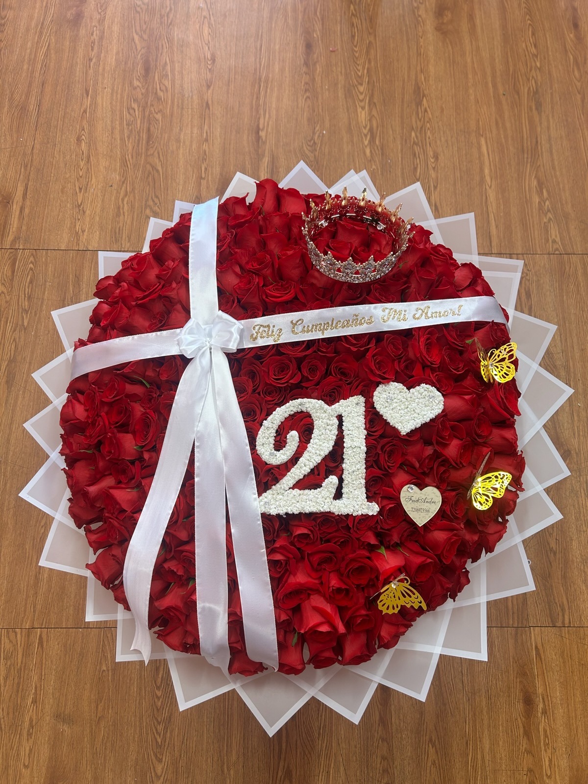 Grand 300-rose red Ecuadorian bouquet with white baby's breath '21' number, floral heart, sparkling crystal crown tiara, 'Feliz Cumpleaños Mi Amor!' ribbon, golden butterflies, and white satin ribbon wrap by FridAndre Florals