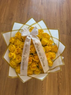 Stunning yellow Ecuadorian rose and bright sunflower bouquet with crystal crown tiara, golden butterfly accents, and elegant white star-point geometric wrap by FridAndre Florals