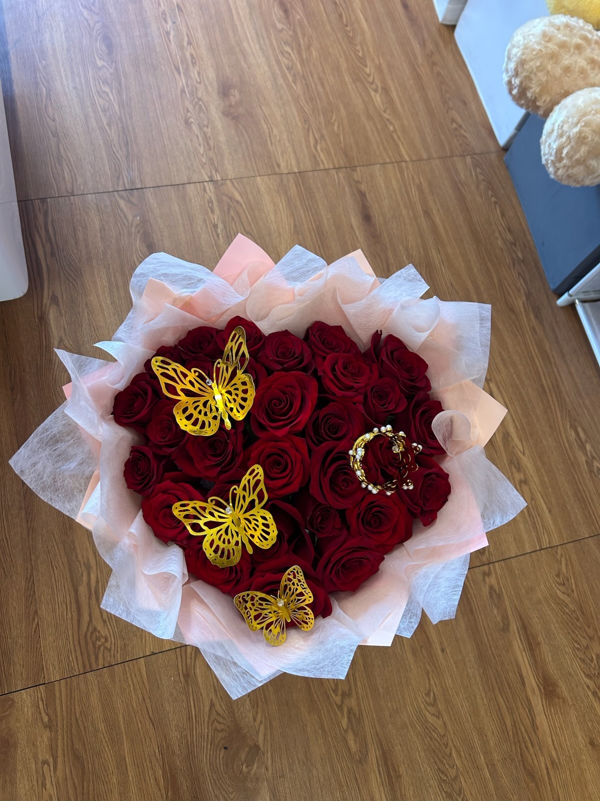 Stunning heart-shaped 25-rose deep red Ecuadorian rose bouquet with sparkling crystal crown tiara, three golden laser-cut butterfly decorations, elegant pink and white tissue paper wrap - luxury romantic heart arrangement by FridAndre Florals