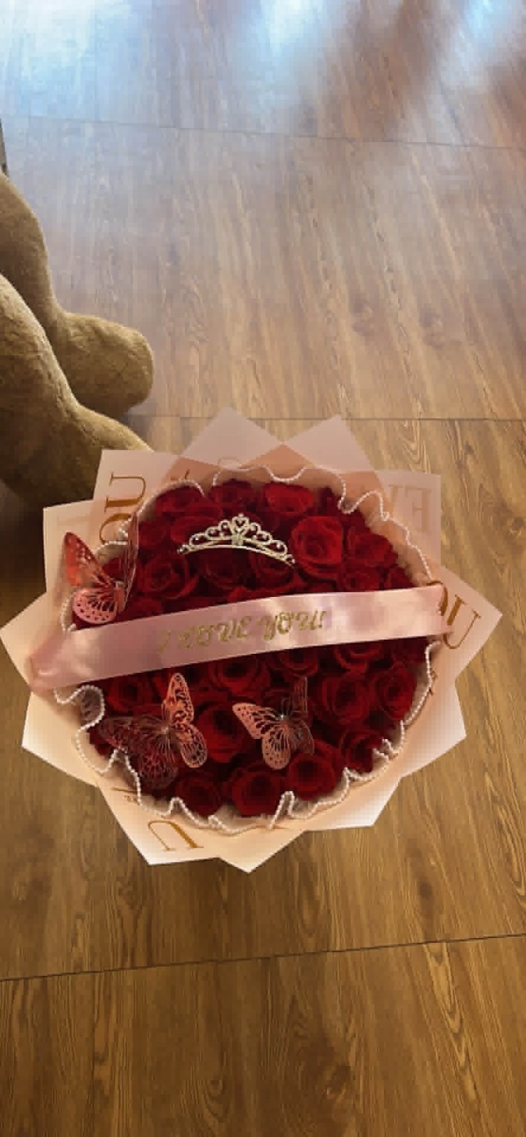 Elegant 36-rose deep red Ecuadorian rose bouquet with sparkling crystal crown tiara, golden laser-cut butterfly decorations, 'I Love You' pink satin ribbon bow, white scalloped edge geometric paper wrap, and pearl border accent - luxury romantic arrangement
