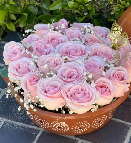Soft pink Ecuadorian roses in ceramic bowl arrangement