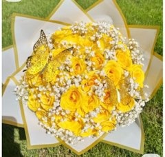 Radiant yellow Ecuadorian rose bouquet adorned with golden butterflies and delicate baby's breath in white and gold star-point wrap by FridAndre Florals