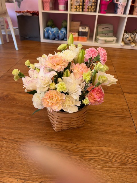 Beautiful floral arrangement with fresh double lilies, peach and pink carnations, and vibrant blooms by FridAndre Florals