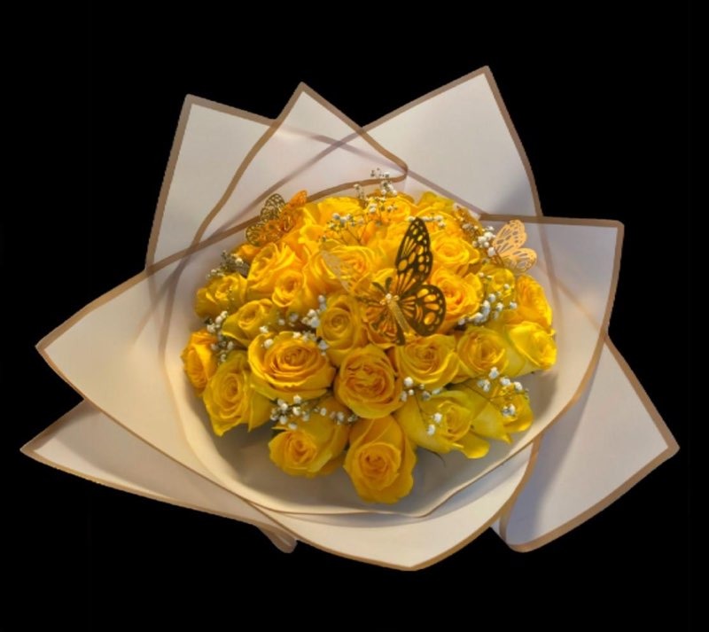 Lush yellow Ecuadorian rose round bouquet with golden laser-cut butterflies and baby's breath accents in white star-point wrap by FridAndre Florals