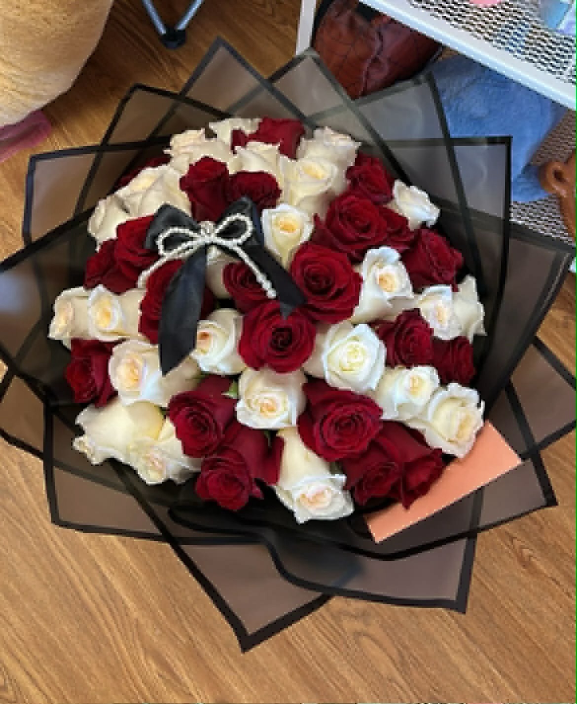 Elegant 50-rose red and cream white Ecuadorian rose round bouquet with black satin ribbon bow with pearl accent, sleek black geometric paper wrap - luxury romantic arrangement by FridAndre Florals