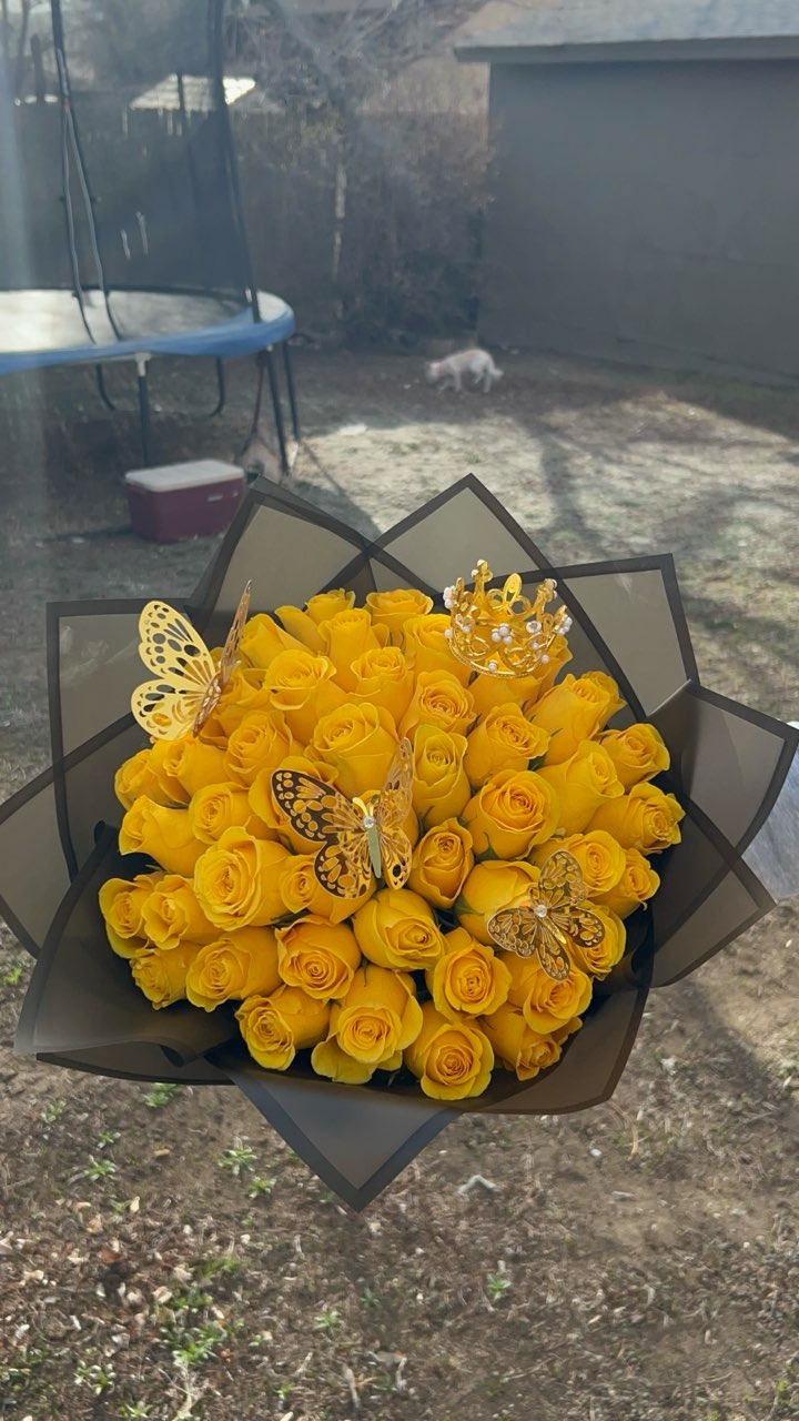 Stunning yellow Ecuadorian rose bouquet crowned with a golden jewel tiara and golden butterflies in sleek black star-point wrap by FridAndre Florals