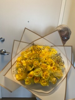 Vibrant yellow Ecuadorian rose bouquet with golden laser-cut butterfly decorations in elegant star-point wrap by FridAndre Florals