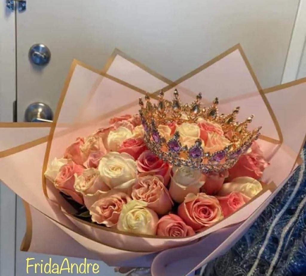 Stunning 50-rose tri-color pink white and cream Ecuadorian rose bouquet with sparkling jeweled crown tiara with purple gemstones, elegant pink geometric paper wrap with gold trim edges, and 'FridAndre' signature - luxury romantic arrangement