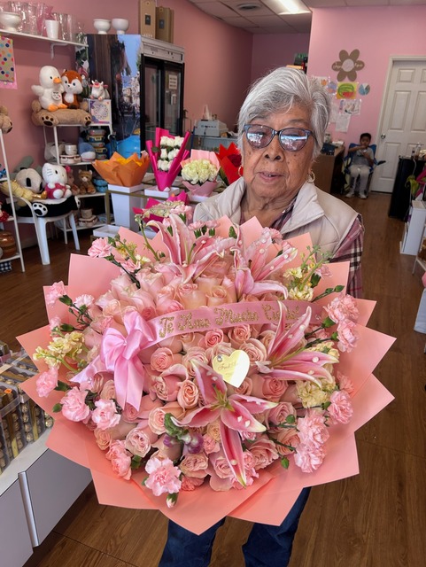 Grand 50-rose soft pink Ecuadorian bouquet with fragrant pink Stargazer lilies, pink carnations, custom 'Te Amo Mucho' ribbon, and pastel pink star-point wrap by FridAndre Florals