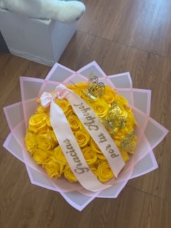 Luxurious bright yellow Ecuadorian rose round bouquet with sparkling crystal crown tiara, golden butterflies, and elegant white geometric wrap by FridAndre Florals