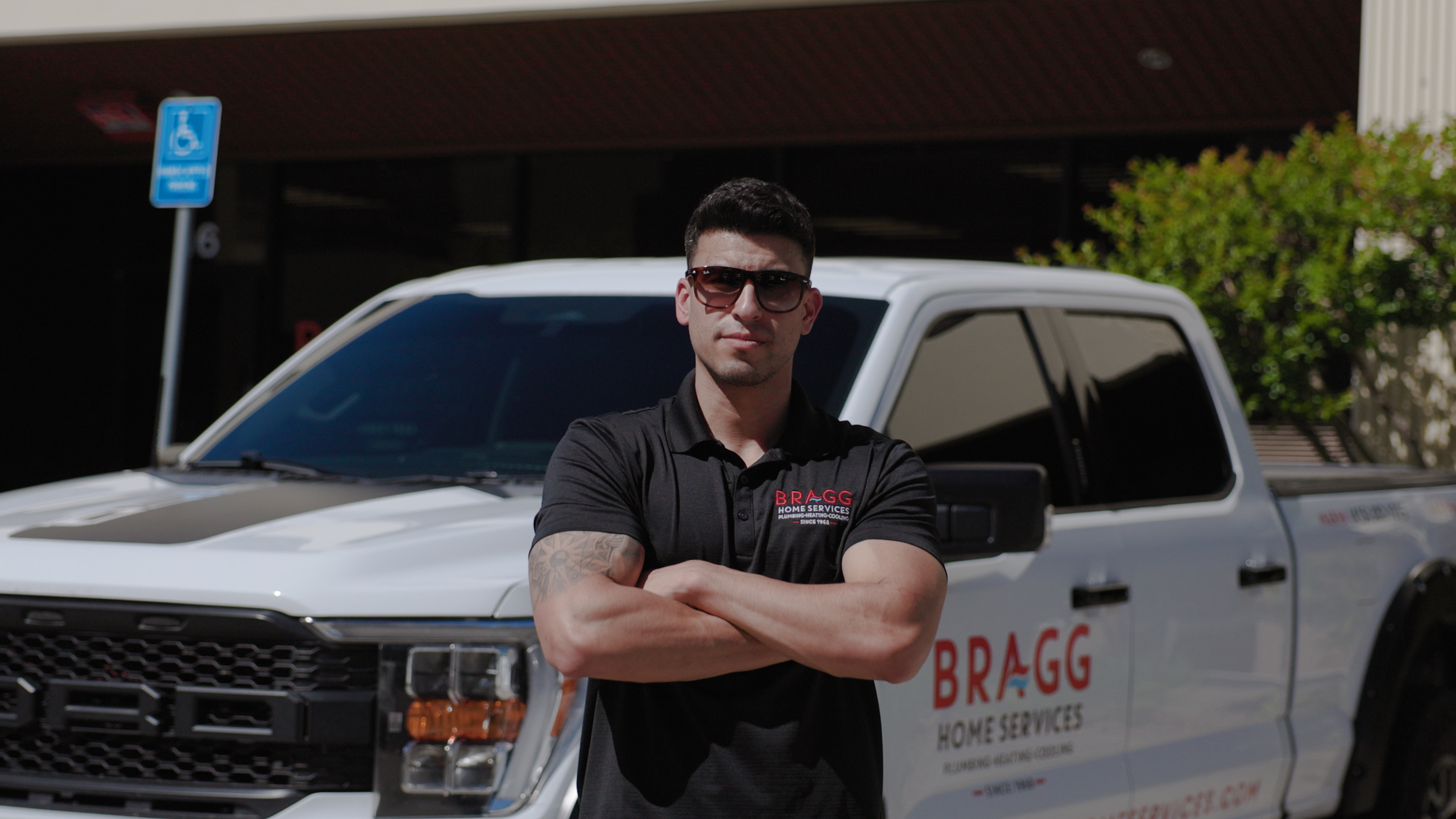 Bragg Home Services technician standing by branded service truck