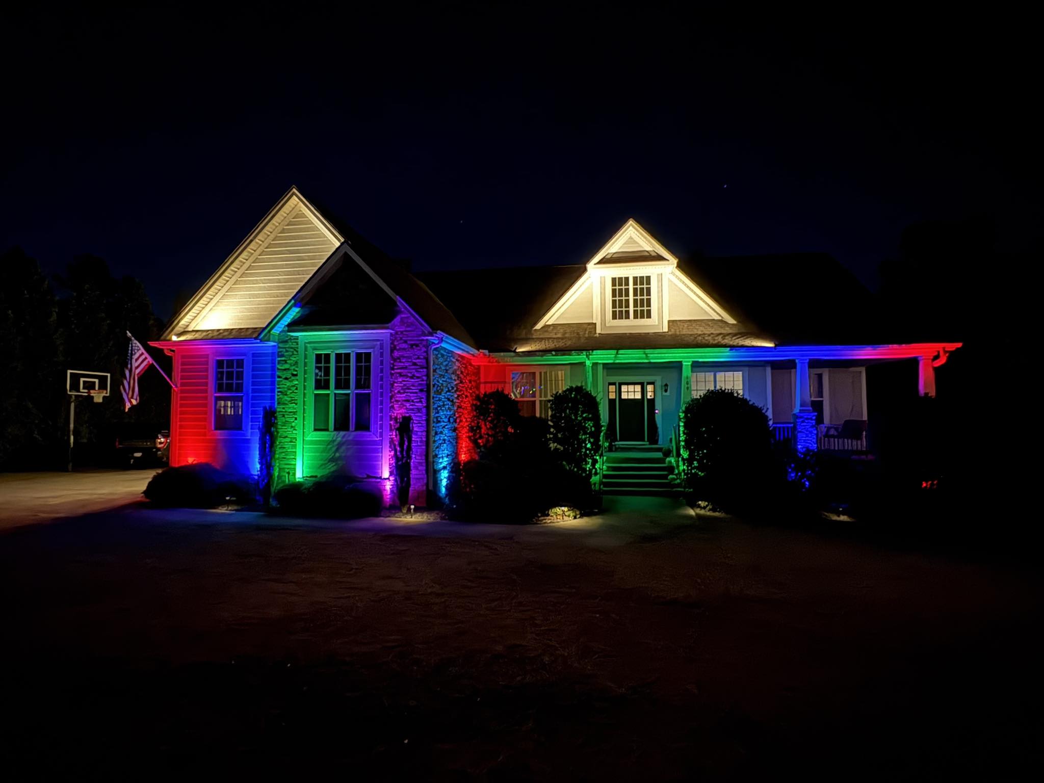 Full spectrum rainbow color-changing RGB smart facade and architectural landscape lighting on luxury home in Simpsonville SC