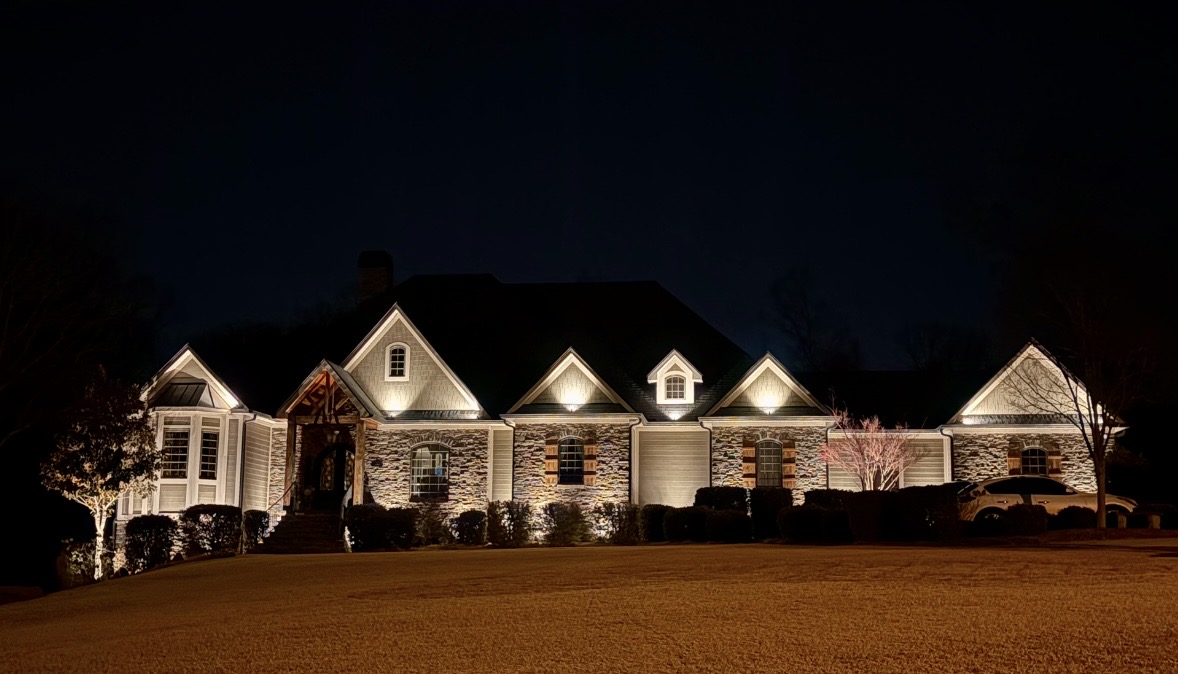 Luxury custom estate stone facade and multi-gable architectural uplighting in Upstate SC
