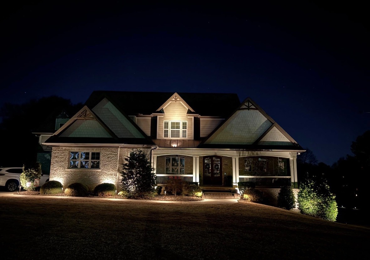Warm architectural gable and walkway landscape lighting on a modern Craftsman home in Upstate SC