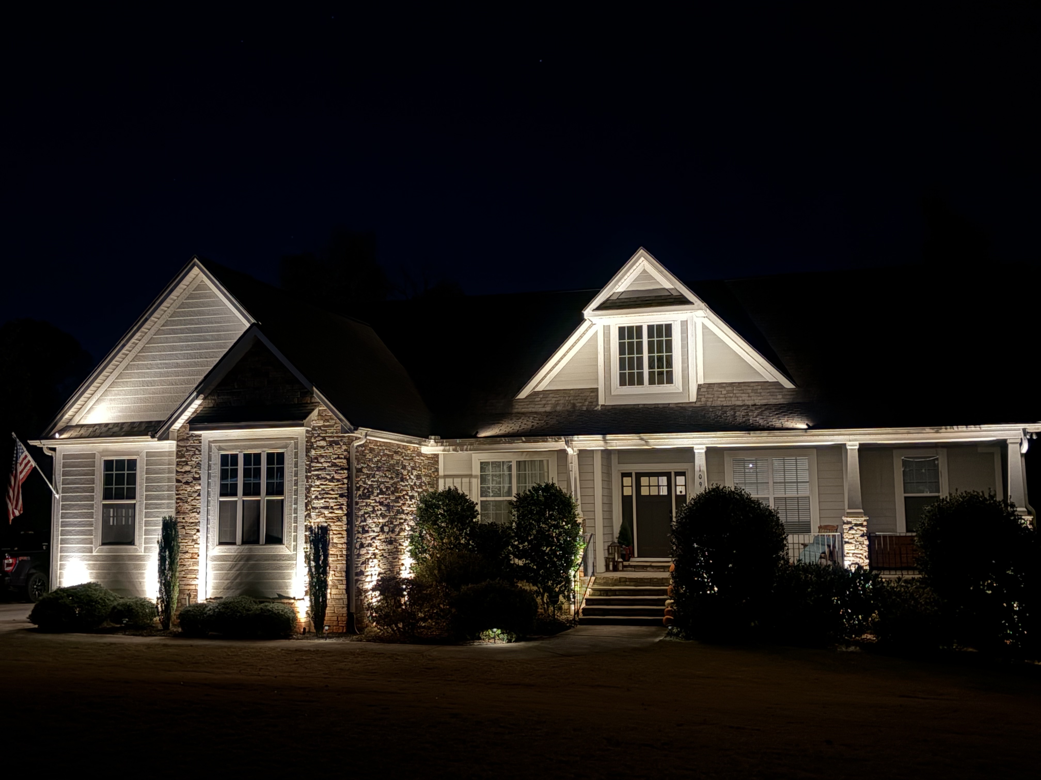 Modern Craftsman residence architectural gables and stone pillar uplighting in Upstate SC