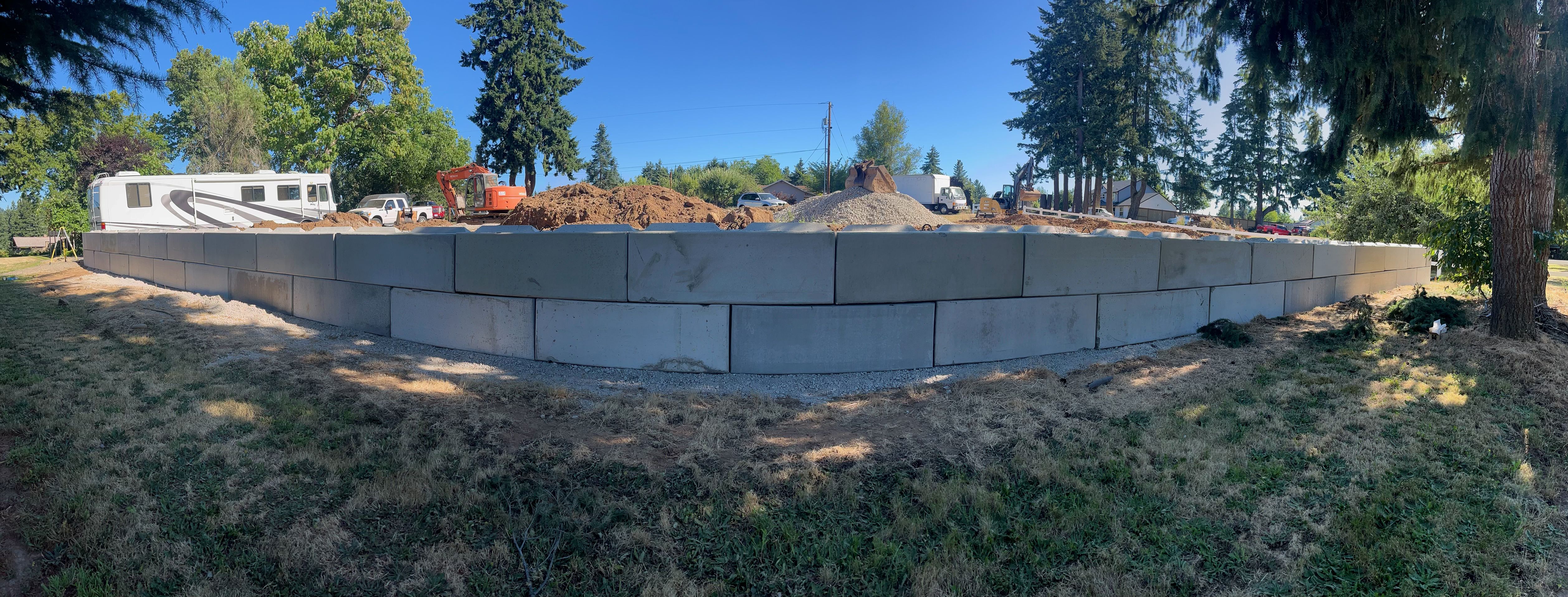Excavation — Completed curved ecology block retaining wall & backfill — representative project image