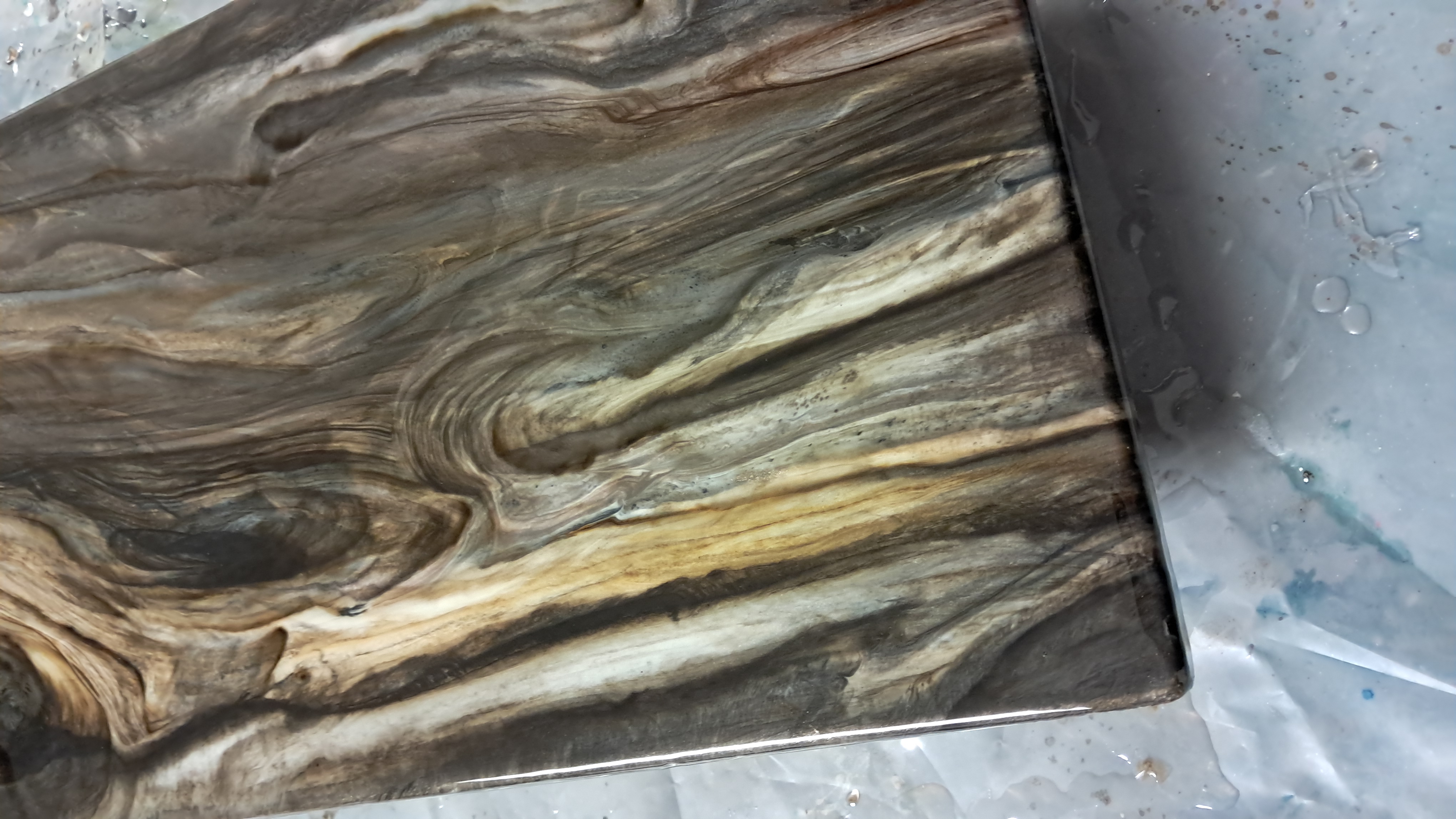Custom wood-grain resin sample with flowing organic patterns by Resin Quarry Customs