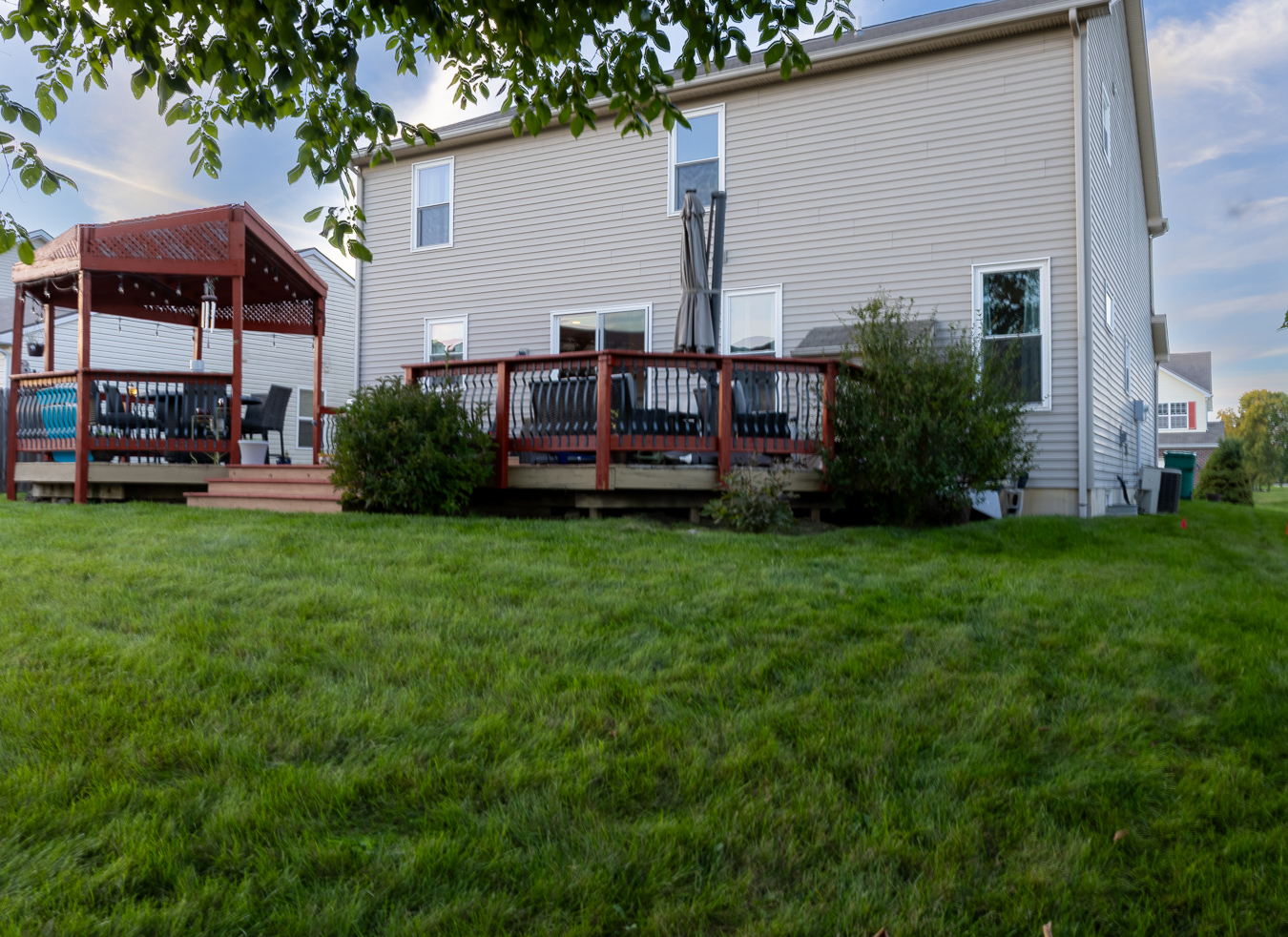 HDR backyard exterior photograph featuring elevated deck, gazebo patio, and manicured yard in Fort Wayne, IN