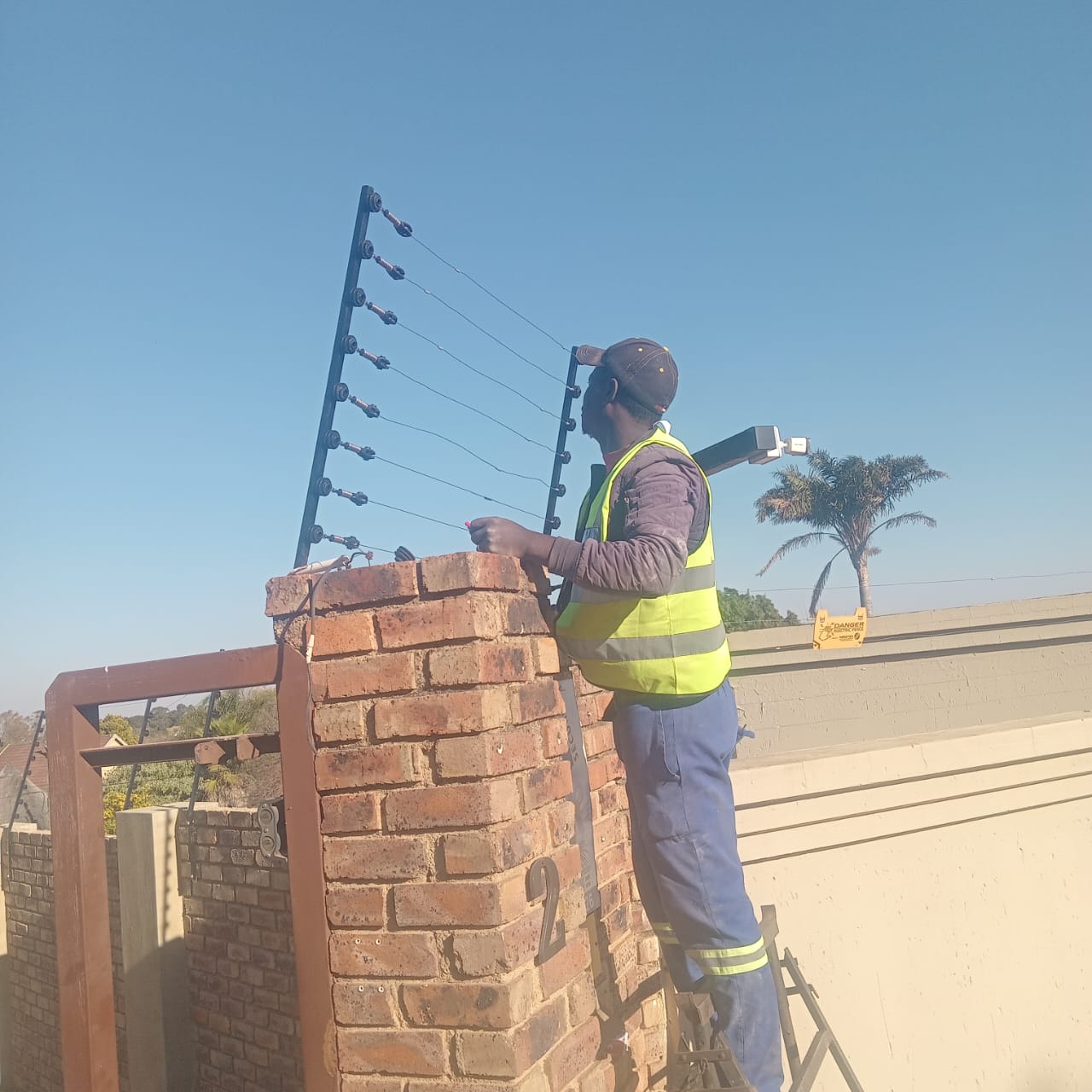 Electric fence installation on brick pillar in Northcliff
