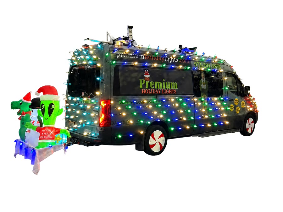 Rear view of Premium Holiday Lights branded van with logo, inflatable characters, and colorful holiday lights