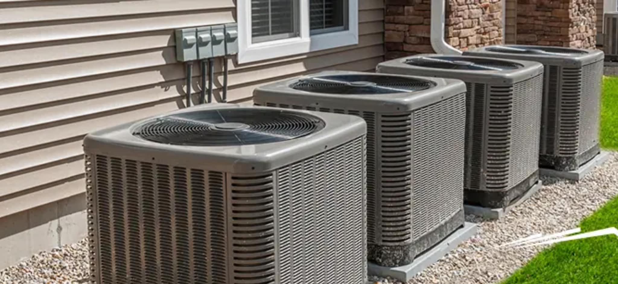 Multiple residential AC condenser units installed in row