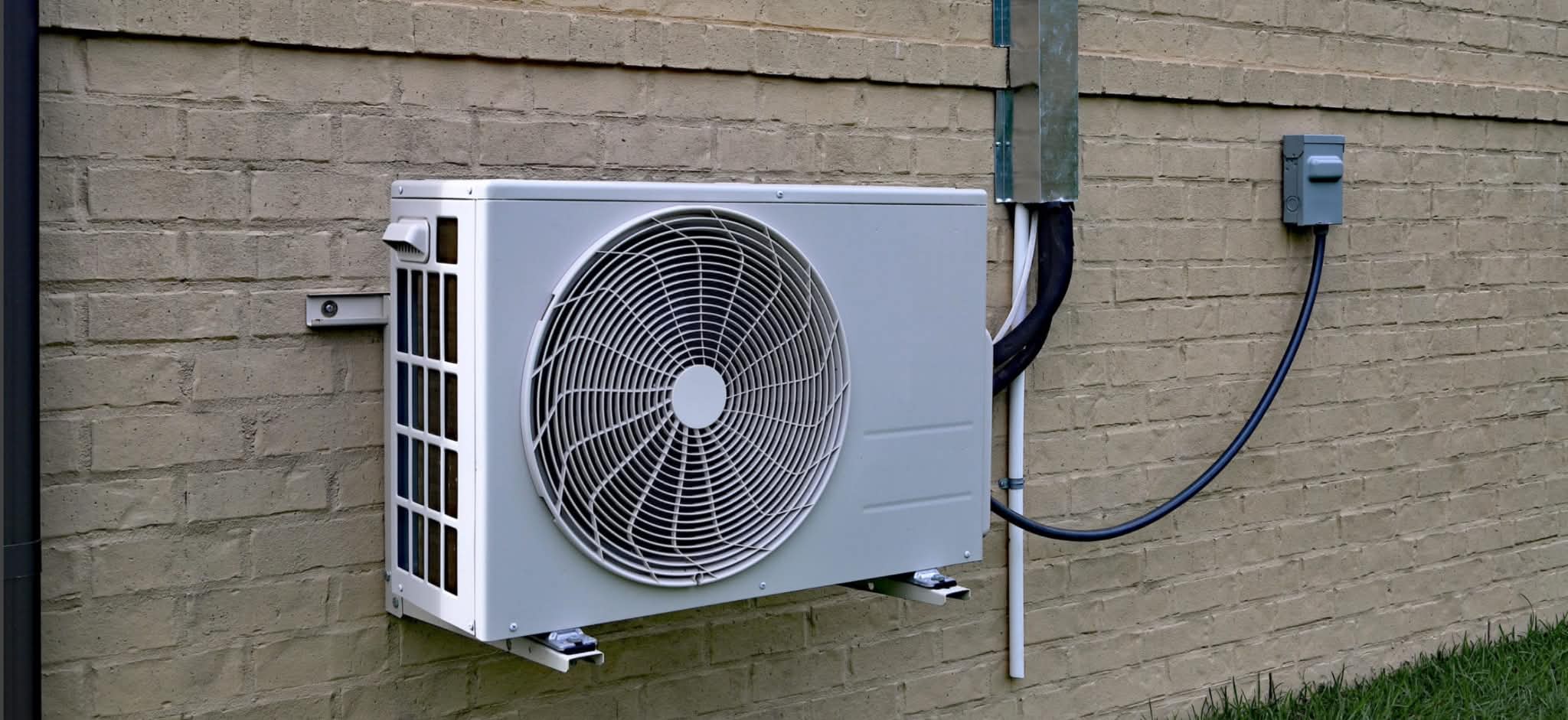 Mini split AC unit installation on brick wall